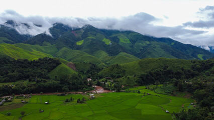 Fototapeta na wymiar Beautiful aerial view of the green rice field and green mountain, Nan, Thailand.