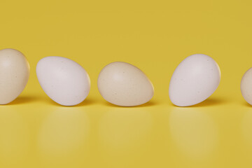Eggs rolling on a yellow background. Sustainable and healthy eating habits
