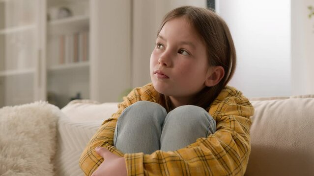 Unhappy stressful depressed caucasian girl schoolgirl sad alone at home thinking psychological problem at school feeling stress anxiety suffering from bullying abuse child punished domestic violence