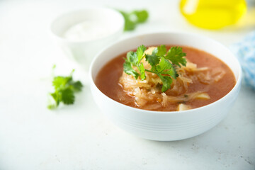 Traditional homemade sauerkraut soup with fresh parsley