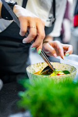 woman chef cooking seafood soup on restaurant kitchen