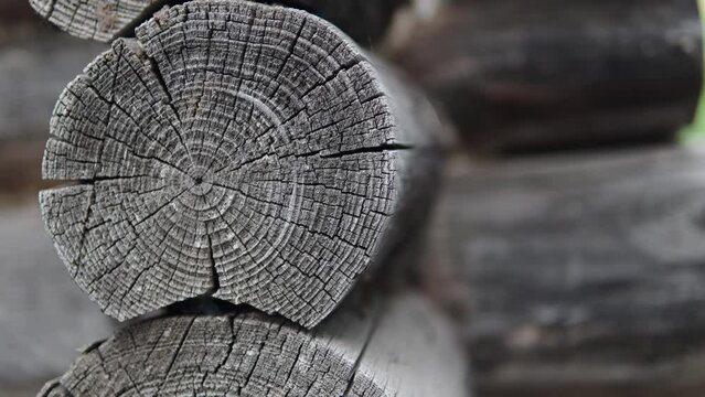 Old log cabin. Old house. Closeup shot camera rising up. An old log house. The logs are very old.