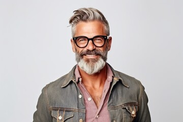 Portrait of a handsome mature man with gray hair and beard wearing eyeglasses