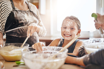 Portrait, playing or messy kid baking in kitchen with a young girl smiling with flour on a dirty...