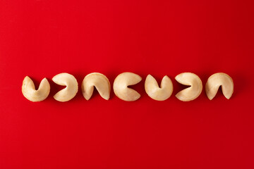 Traditional fortune cookies on red background