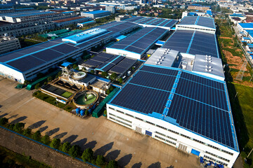 Aerial photography of solar photovoltaic panels built on the roof of a factory building