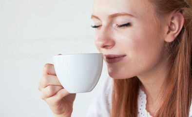Face of woman smell her cup of coffee in a studio for a scent in the morning on a weekend. Calm,...