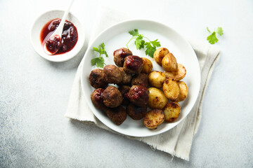 Homemade veal meatballs with potato and berry sauce