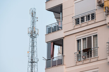 a cell tower emits dangerous radiation near residential buildings. Conspiracy theory concept
