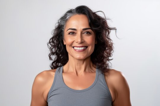 Portrait of a smiling middle-aged woman in sportswear looking at camera