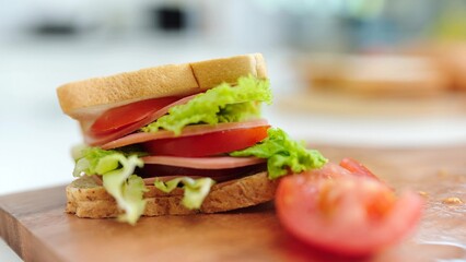 Close up sandwiches on wooden tray. Delicious sandwich with vegetables, ham, tomatos, lettuce. Tasty and fresh sandwiches