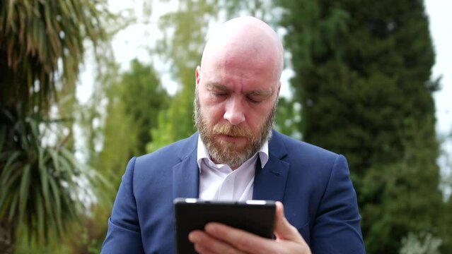 Angry frustrated man throwing tablet down in anger