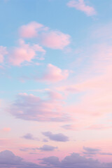 The setting sun casts a mesmerizing afterglow across the horizon, illuminating the mountain peaks and calming waters below while delicate pink clouds drift in a brilliant blue sky
