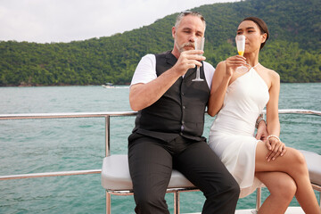 couple drinking and looking each other in luxury yacht