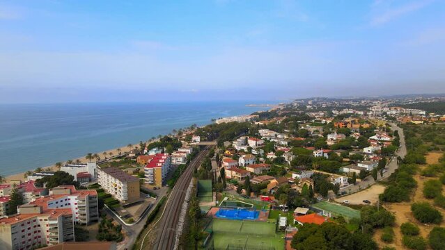 Aerial 4K drone footage of Coma-Ruga, a picturesque city in Spain, during the vibrant springtime.