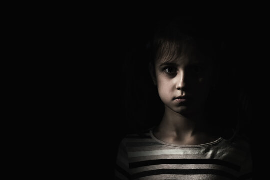 Conceptual image: psychological injuries, children's anxieties and fears, lost childhood. Sad unhappy little child girl feel lonely abandoned, children drama. Copy space.