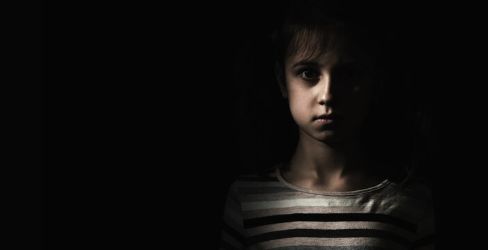 Conceptual image: psychological injuries, children's anxieties and fears, lost childhood. Sad unhappy little child girl feel lonely abandoned, children drama. Copy space for text or design.