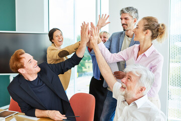 Happy business people as team giving high five for motivation