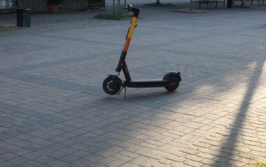 Electric scooter outside on a sunny day, with no one around
