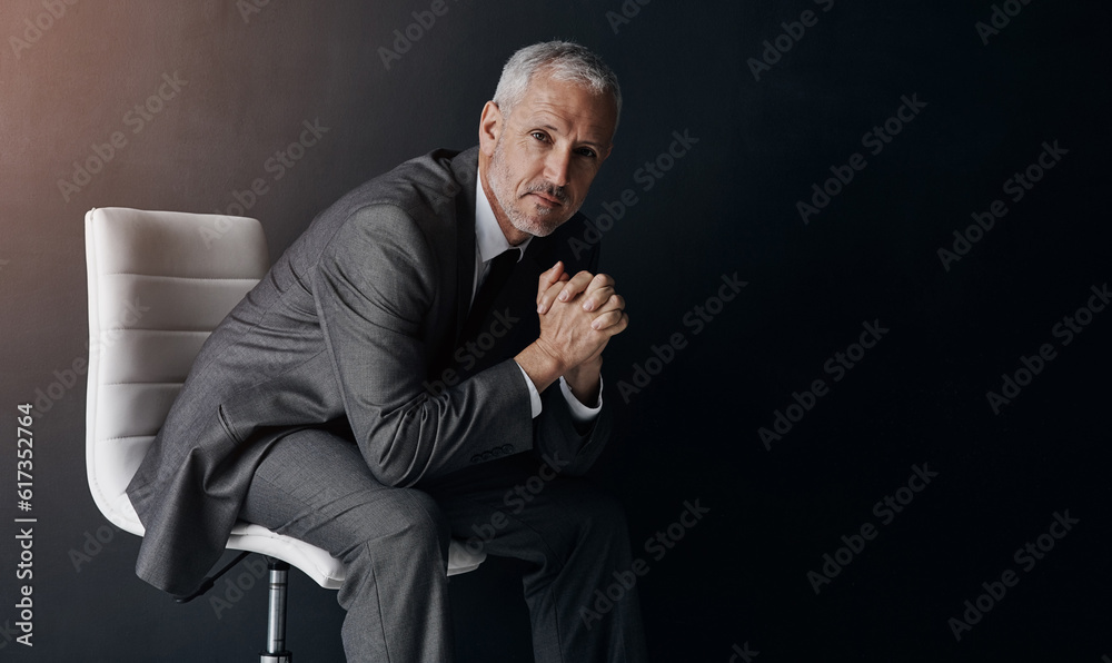 Canvas Prints Portrait, manager or corporate with a business man sitting on a chair in studio against a dark background. Leadership, management and a senior male CEO in a professional suit for his executive career