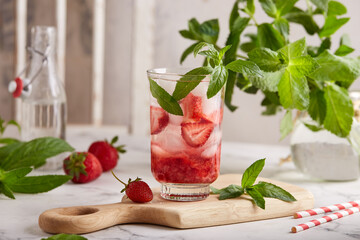 Lemonade with strawberries, ice cubes, and mint. Refreshing cold spring and summer fruit or berry beverage.