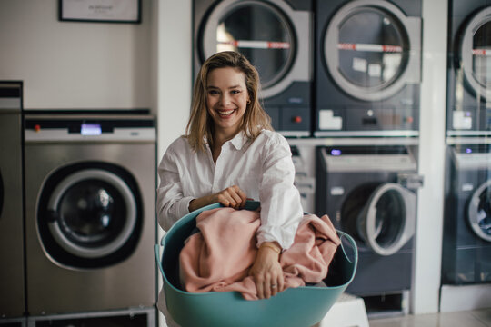 Young woman posing in a laundry room.
