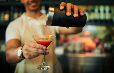 Barman hands, cocktail glass and man make alcohol beverage at pub, night club or drinks bar. Hospitality service, restaurant barmen and male nightclub person prepare fruit drink, liquid or liquor