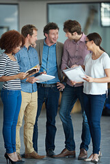 Team planning, talking or business people with ideas in meeting for brainstorming together in office. Diversity, digital or IT employees networking with technology, notes or documents in workplace