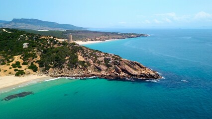 Faro de Camarinal, aerial view of the lighthouse on a cliff at the the wonderful sandy beach with the blue turquoise Atlantic Ocean, Playa Los Alemanes, Andalusia, Spain © keBu.Medien