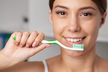 Happy Lady Brushing Teeth With Toothbrush Standing In Bathroom