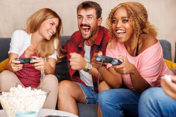 Friends playing video games and having fun at home