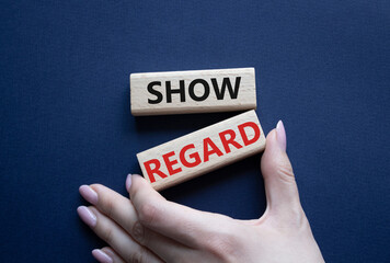 Show regard symbol. Wooden blocks with words Show regard. Beautiful deep blue background. Businessman hand. Business and Show regard concept. Copy space.