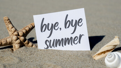BYE BYE SUMMER text on paper greeting card on background of starfish seashell summer vacation decor. Sandy beach sun coast. Holiday concept postcard. Getting away Travel Business concept