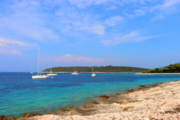 Fototapeta na wymiar Beautiful wild beach and sailing boats on Proizd, small island near island Korcula, Croatia.