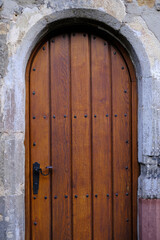 brown antique old fashioned wooden door texture, wall, historic building, castle entrance with doorknob, brown natural wood texture, background for designer with copy space, empty mock up