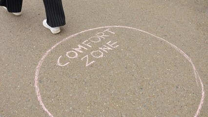 Woman in black trousers and white sneakers decides to leave comfort zone and go towards adventures.