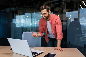 Effective and successful businessman talking on video call with colleagues, online meeting. An...