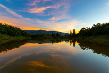 Fototapeta na wymiar Beautiful sunset sky with reflection of the lake at Khao Yai national park, Thailand