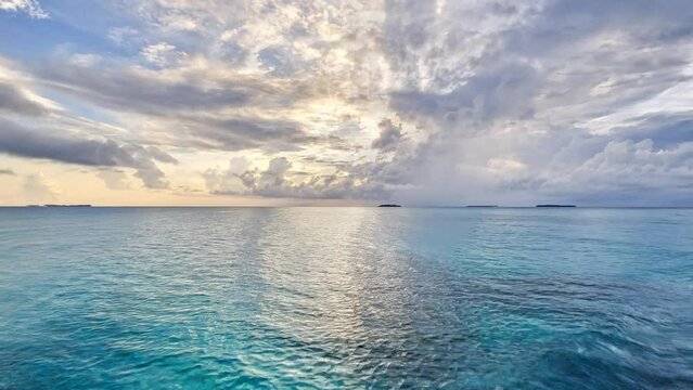 Footage captures the serene beauty of a breathtaking sunset over turquoise waters in the middle of the sea