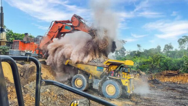 The dusty materials are transported by the mining truck, while the diligent excavator tirelessly delves into the depths of the earth's layers