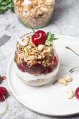 Granola with yogurt and cherries in a glass