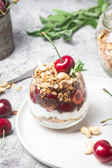 Granola with yogurt and cherries in a glass