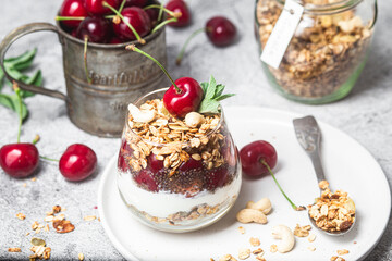 Granola with yogurt and cherries in a glass