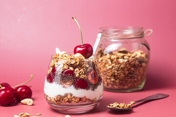 Granola with yogurt and cherries in a glass