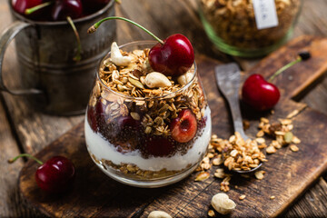 Granola with yogurt and cherries in a glass