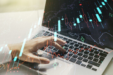 Double exposure of abstract creative financial chart with world map and with hands typing on computer keyboard on background, research and strategy concept