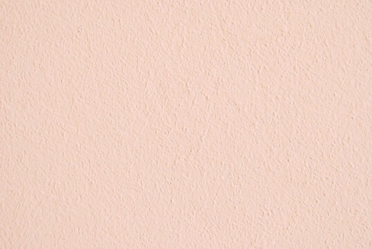 Light pink plastered wall background, plastered texture