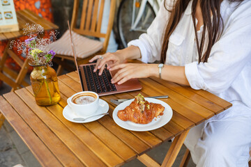 Obraz na płótnie Canvas Creative professional types on laptop at cafe.