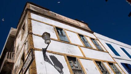 Building with blue shutters and yellow trim in the Medina in Essaouira, Morocco