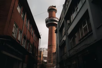 Gordijnen Low Angle Photo Of Tower Near Buildings, Generative AI. © Box Milk